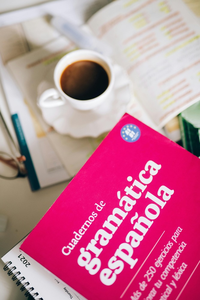 Spanish grammar notebook with coffee on a table