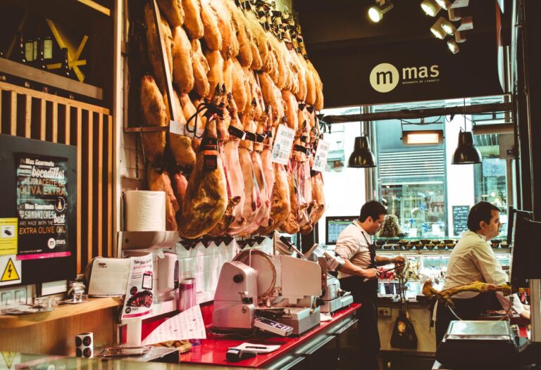 Traditional Spanish cured ham legs hanging in a local market