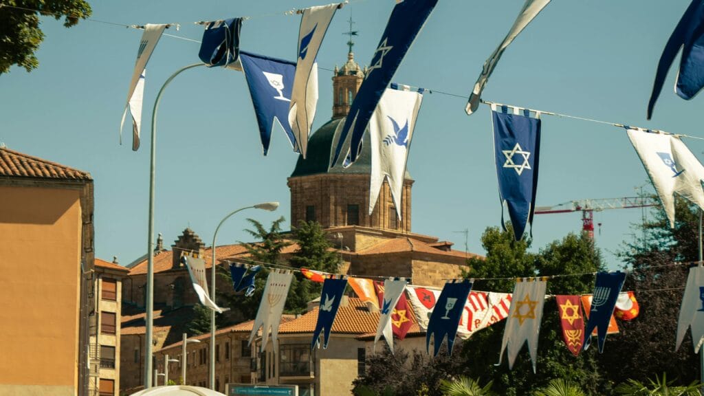 Decorated street with colorful banners in Salamanca, celebrating local festivals