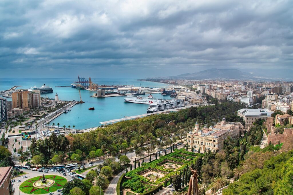 Panoramic aerial view of Málaga with its historic center, modern port, and Mediterranean coastline