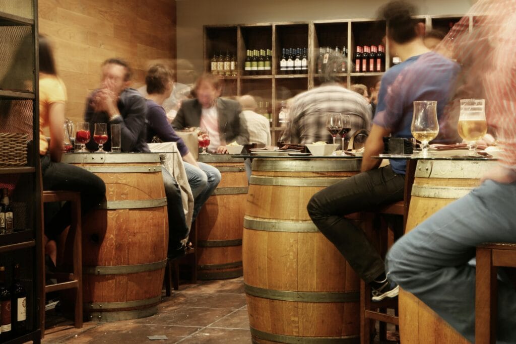 Traditional bar in León with barrel tables, a popular spot for students to enjoy tapas