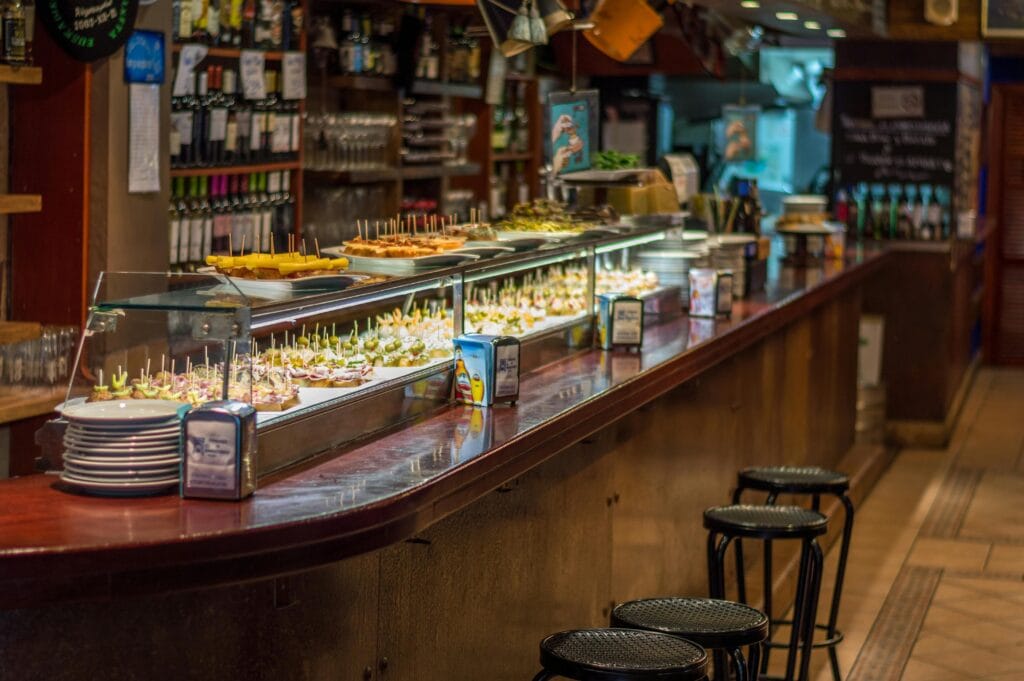 Traditional Spanish tapas bar with a variety of colorful tapas on the counter